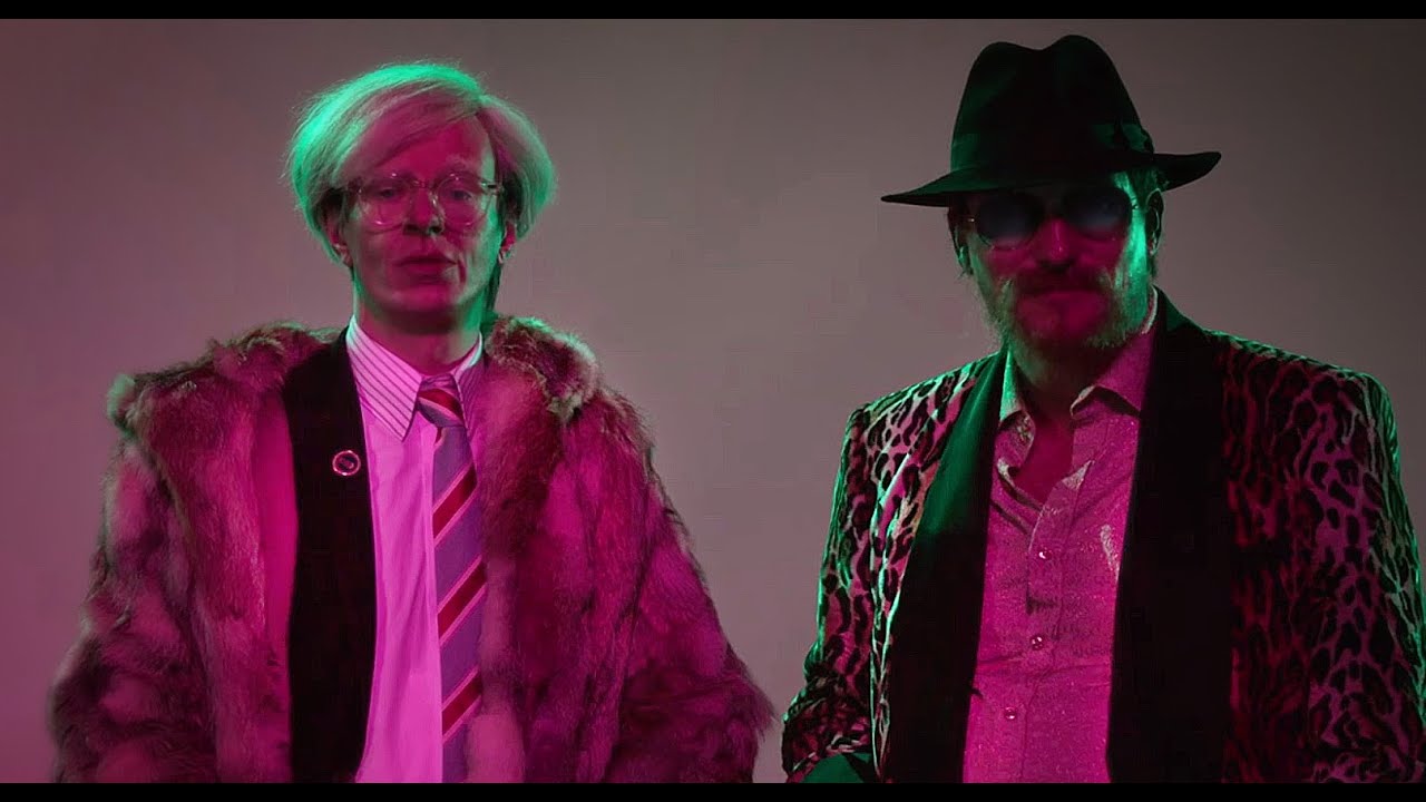 ALEXANDER SCHEER as ANDY WARHOL and OLIVER MASUCCI as RAINER WERNER FASSBINDER
