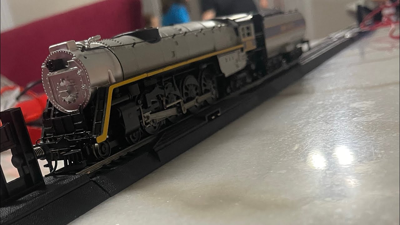 Train race around Christmas tree.