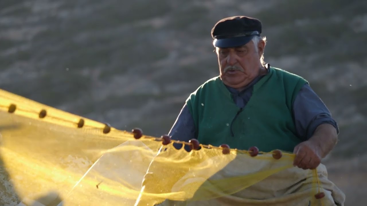 Amorgos greece older fisherman port untangling fishing nets slow motion 04 24
