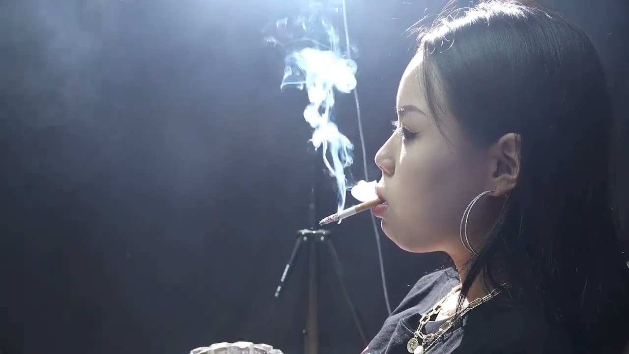 The girl was enjoying the cigarette intensely.