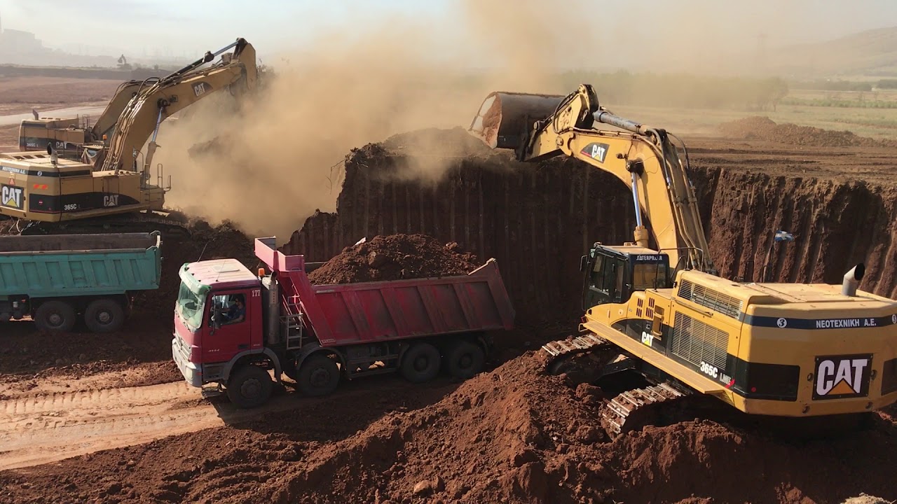 Three Caterpillar 365C Excavators Working By Side