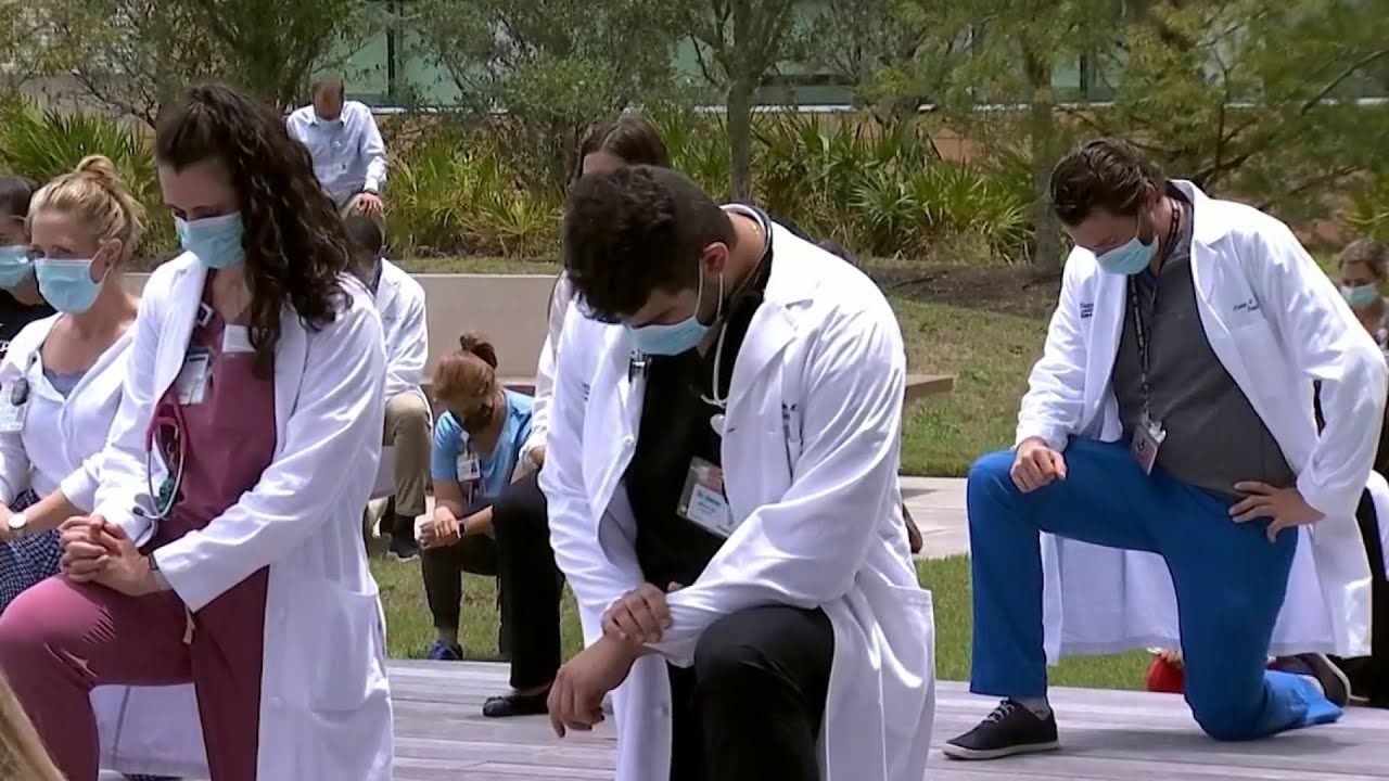 Nemours Children’s Hospital staff kneel in silence in support of ‘White Coats 4 Black Lives’ mov...