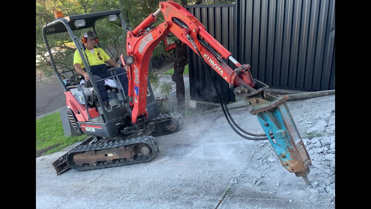 Mini Excavator hydraulic hammer breaking up concrete