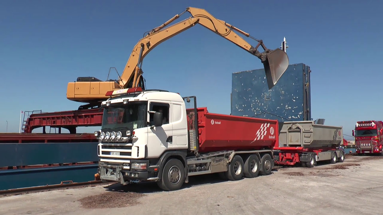 Komatsu excavator loads gravel on Scania trucks in Visby harbor 2013
