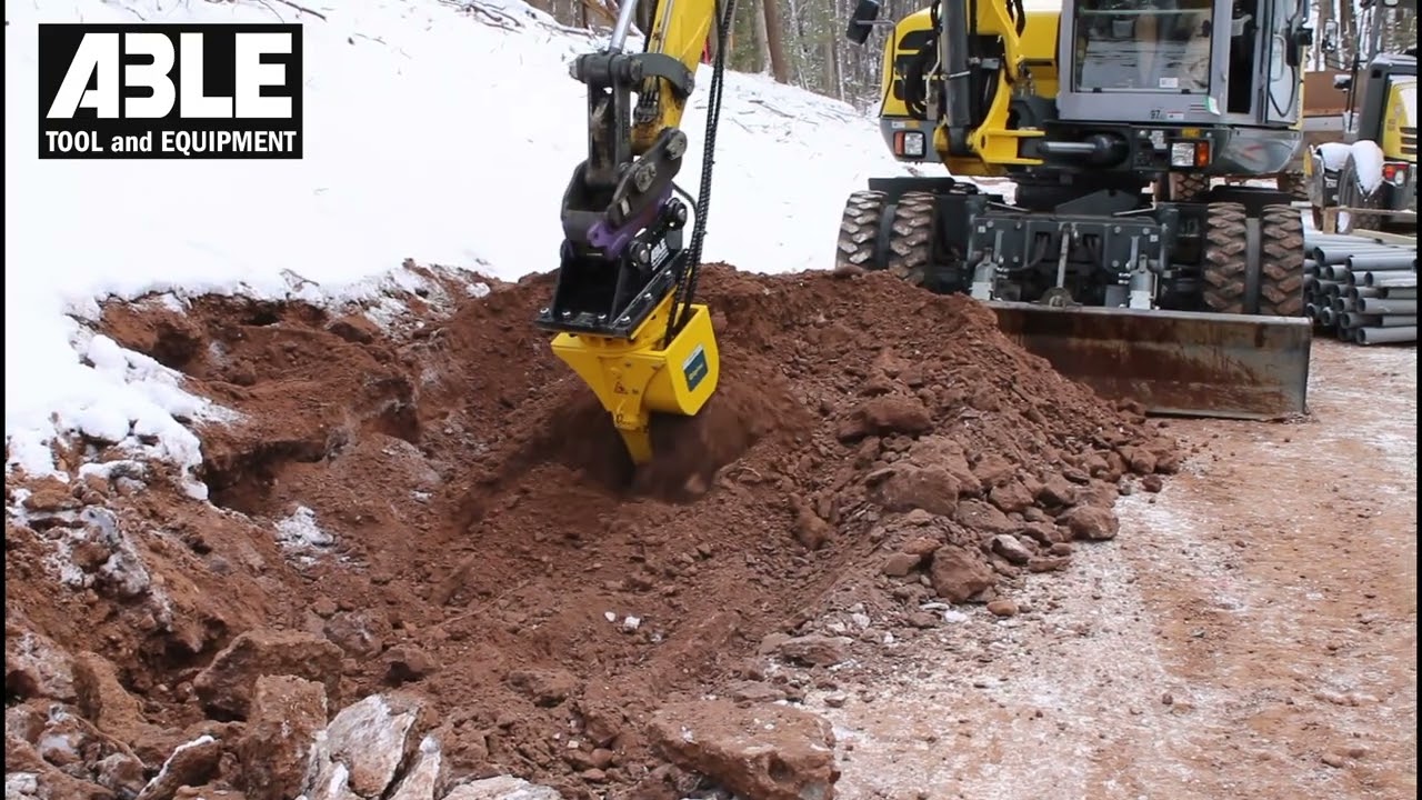 Wacker EW100 Wheeled Excavator with Epiroc ER250 Drum cutter attachment, cutting frost in CT
