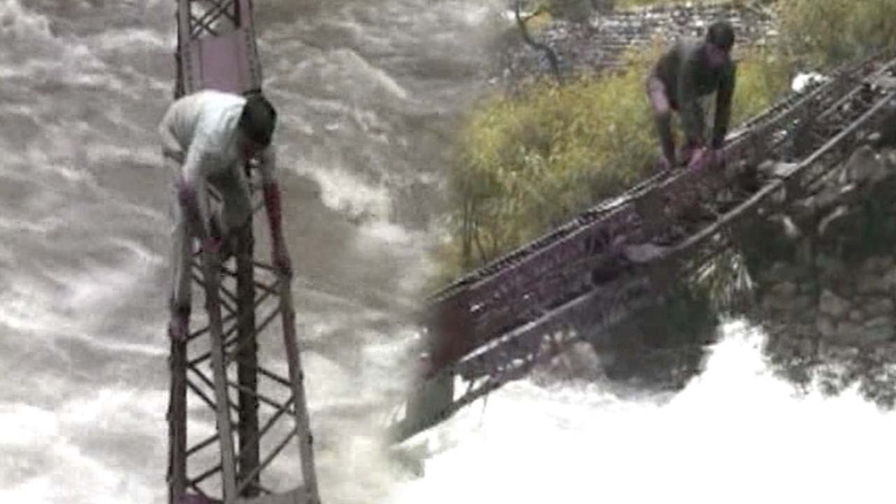 Watch | Uttarkashi villagers risk life, cross trench with flood water on overhead rail