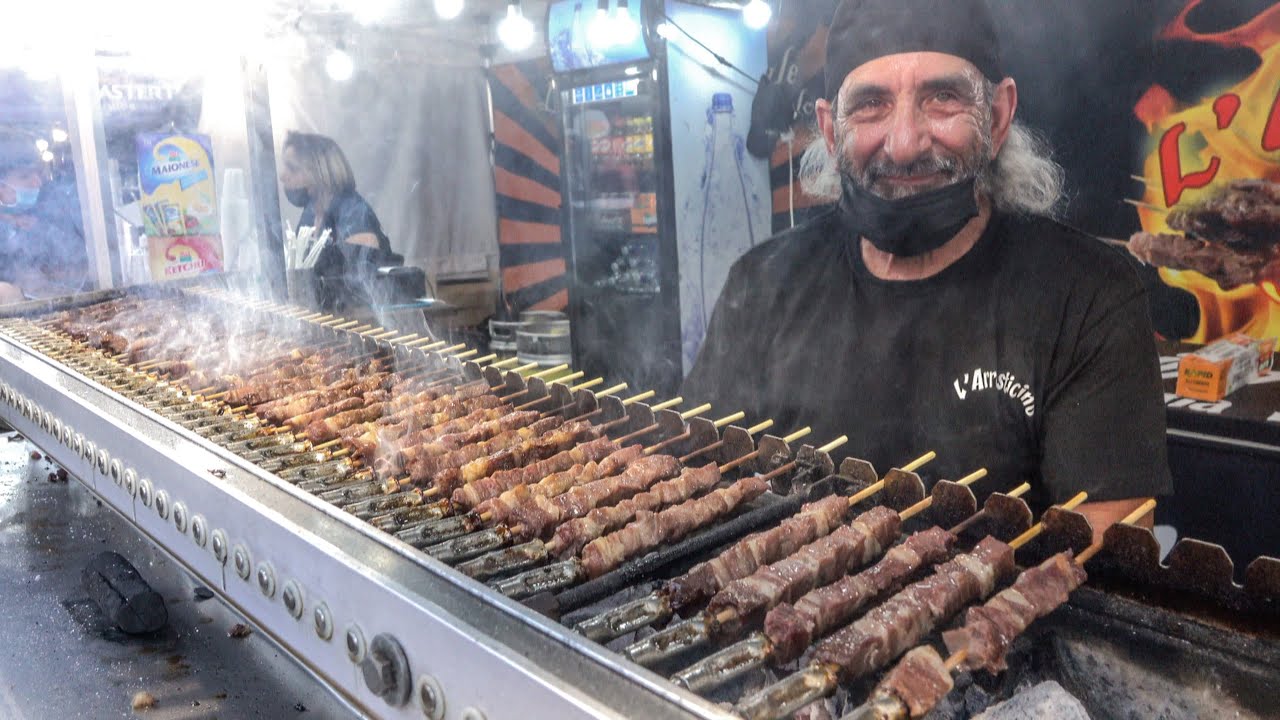 Italy Street Food Fair. Small Sticks of Sheep Meat Roasted on Charcoal. 