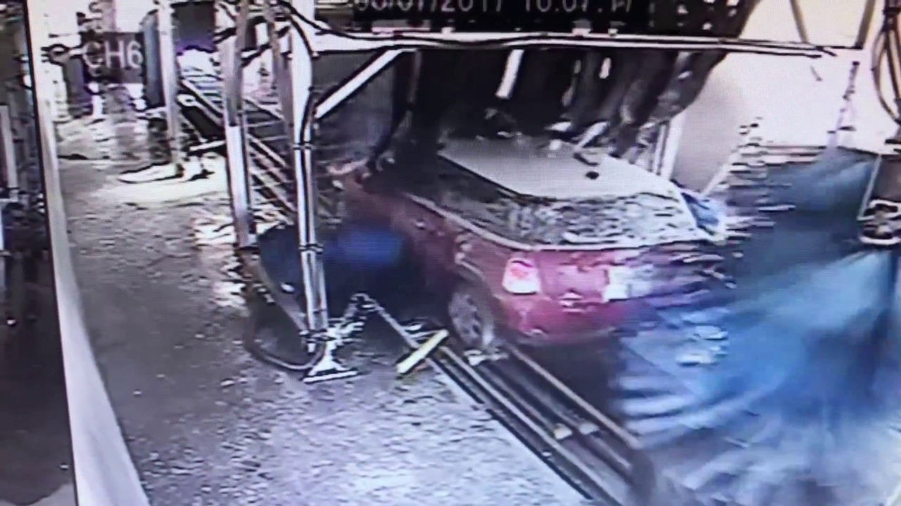 Man backs into another car at the car wash