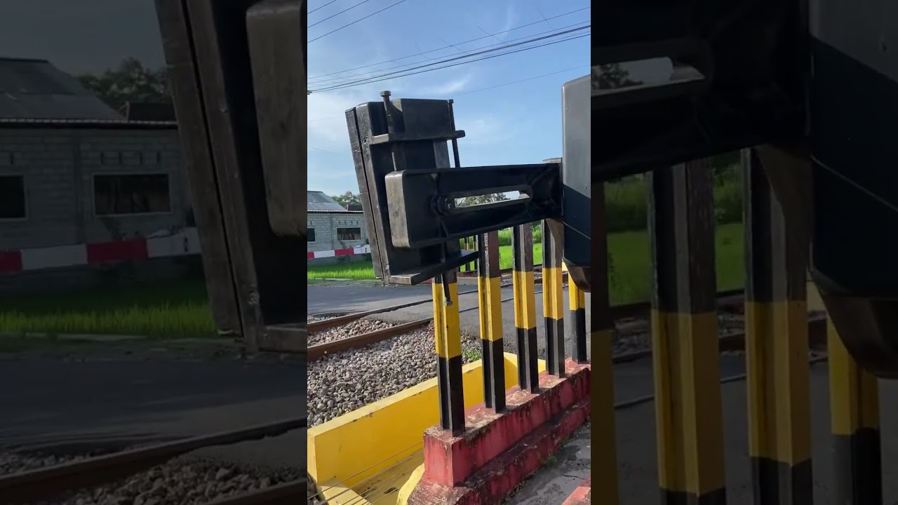Railroad crossing with an Approaching highspeed brand new train..#keretaapiindonesia#kamajapahit