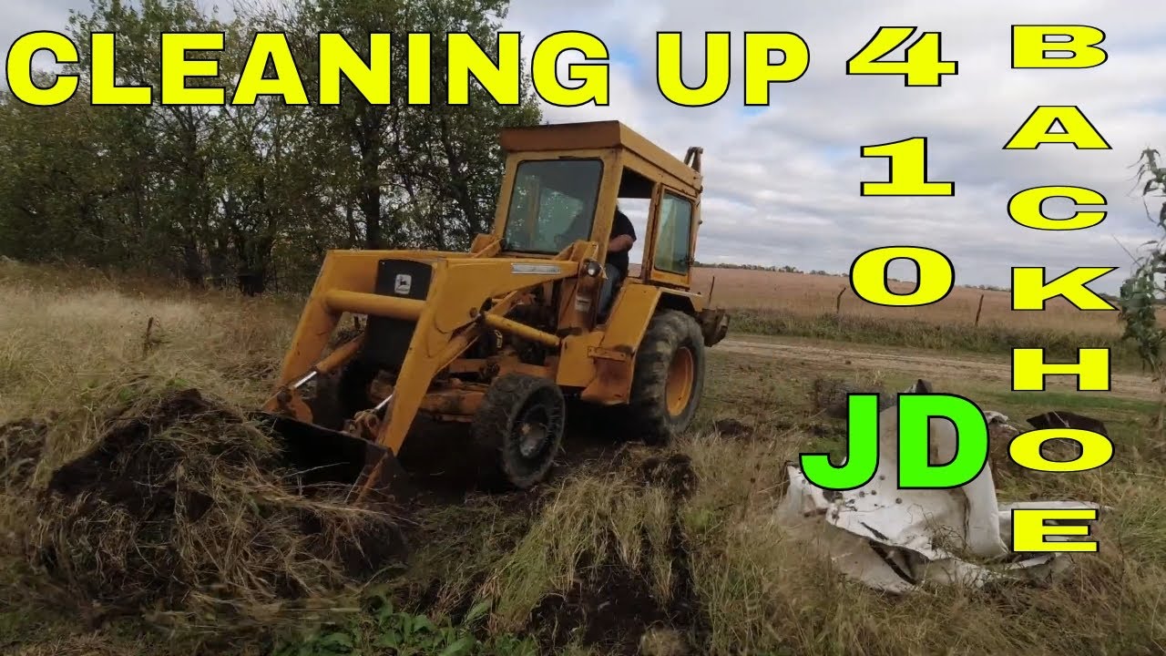 Clean up and pulling trees with the John Deere 410 Backhoe Loader