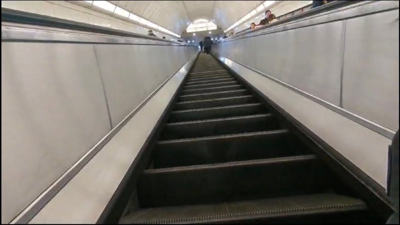 Riding up and down the escalator at Angel tube station.