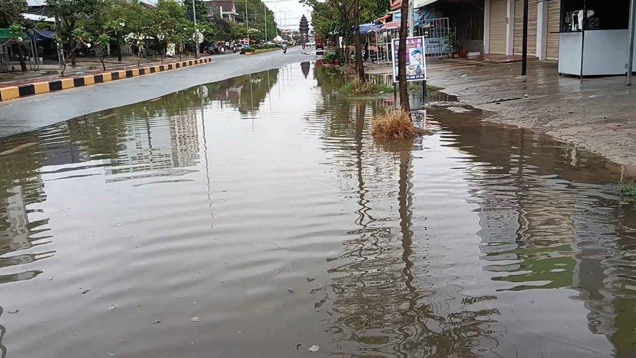 Drain water on the street after heavy rain to clogged garbage drain