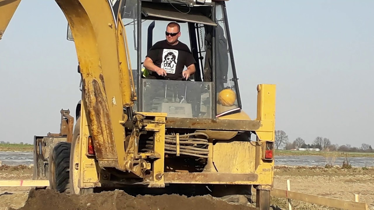 Cat 428c zbieranie humusu pod fundamenty