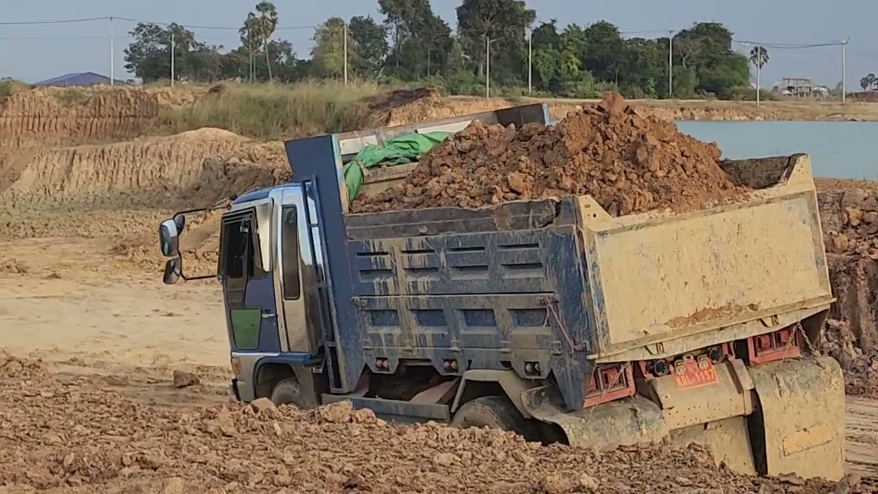 Many dump trucks are waiting Excavator CAT 320D2 GC