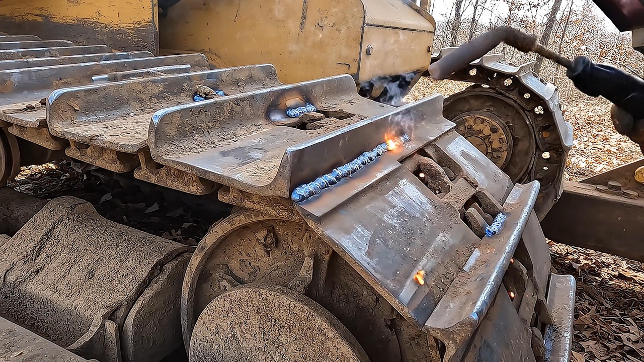 Welding on new grouser bars on worn track pads