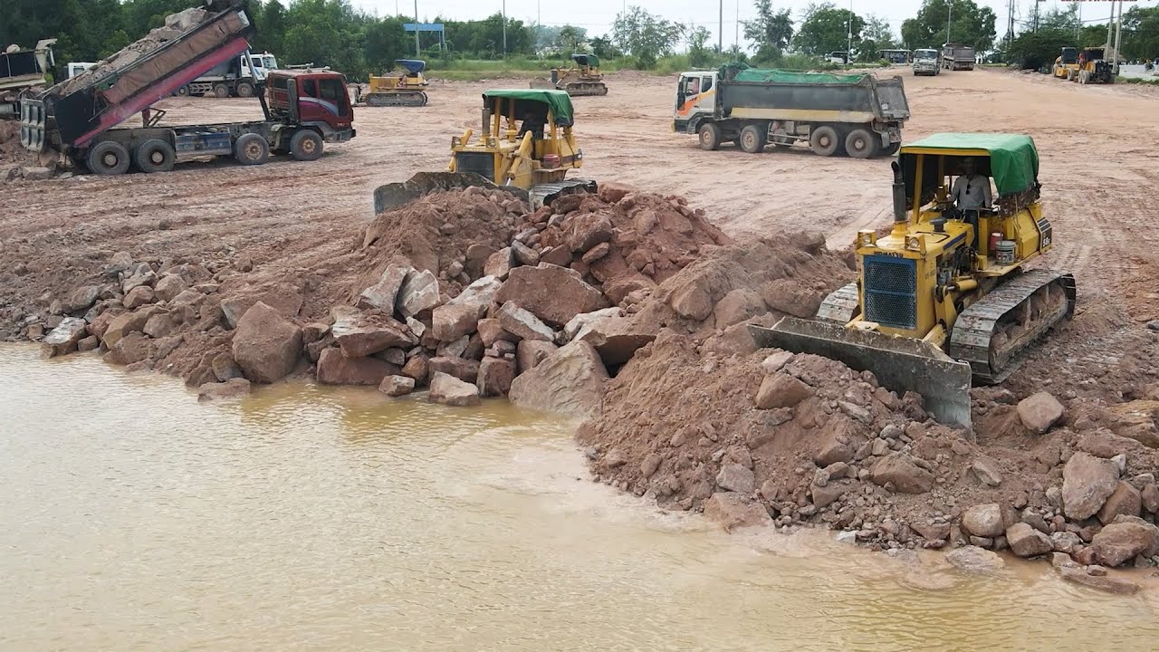 Great Stone Move On Landfill Project Using By Team KOMATSU Bulldozers Push Into Low Area With Trucks