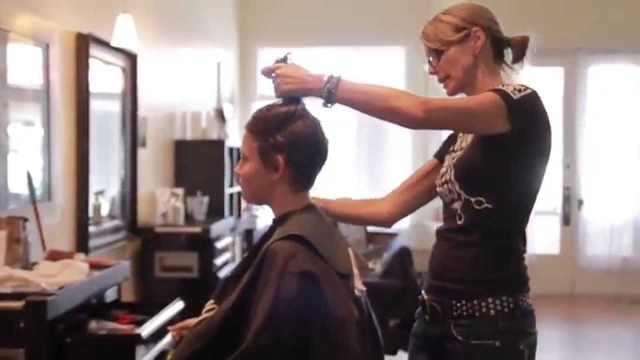 haircut on long strawberry blonde hair going for pixie cut