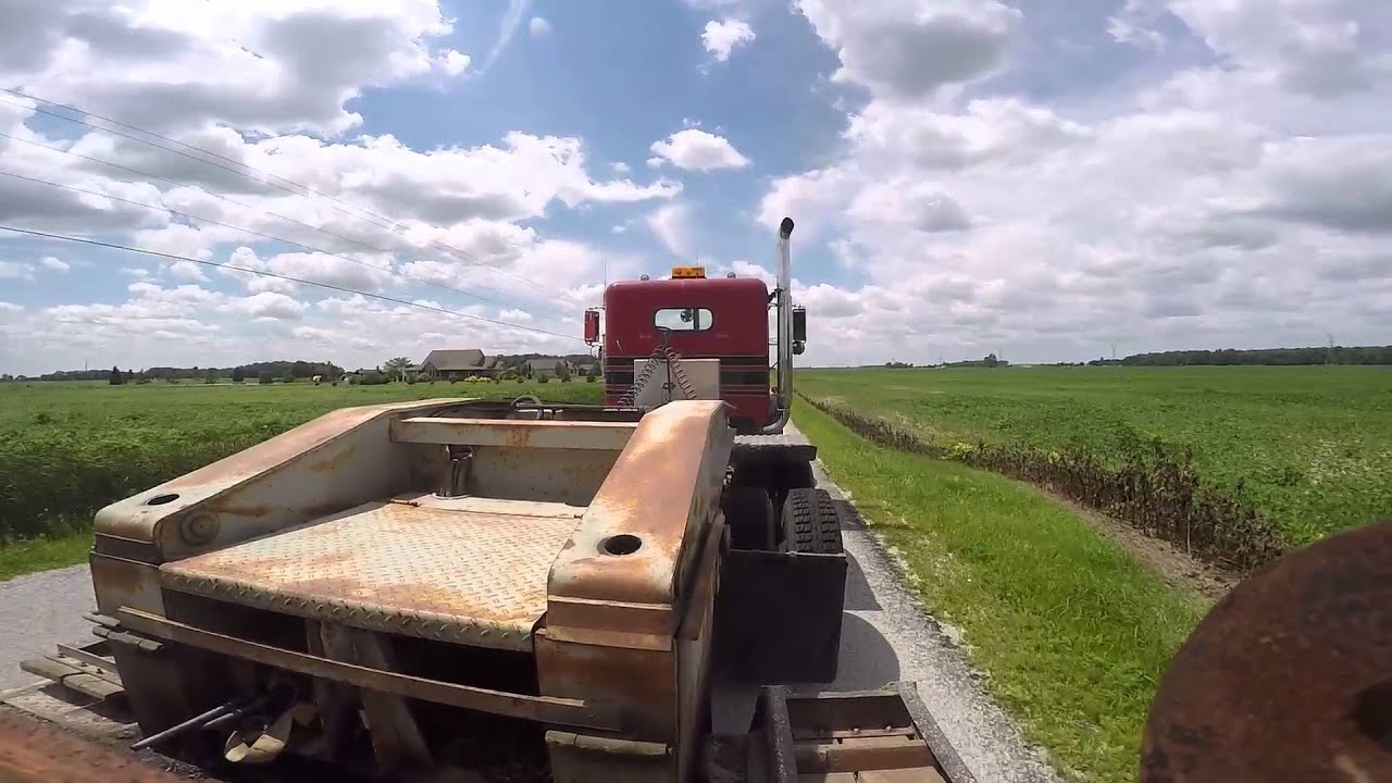1979 Freightliner with VT903 V8 Cummins hauling John Deere 410 backhoe