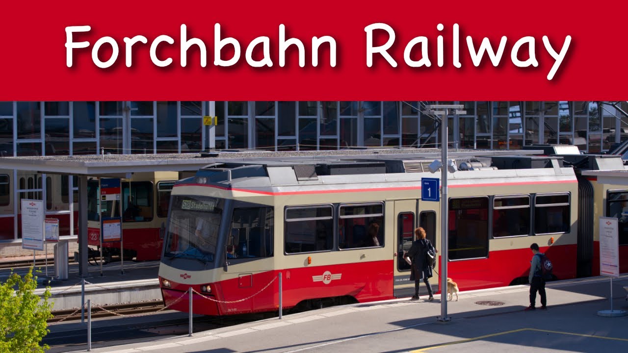 Zurich Forch Railway train leaving train station on a sunny spring day.