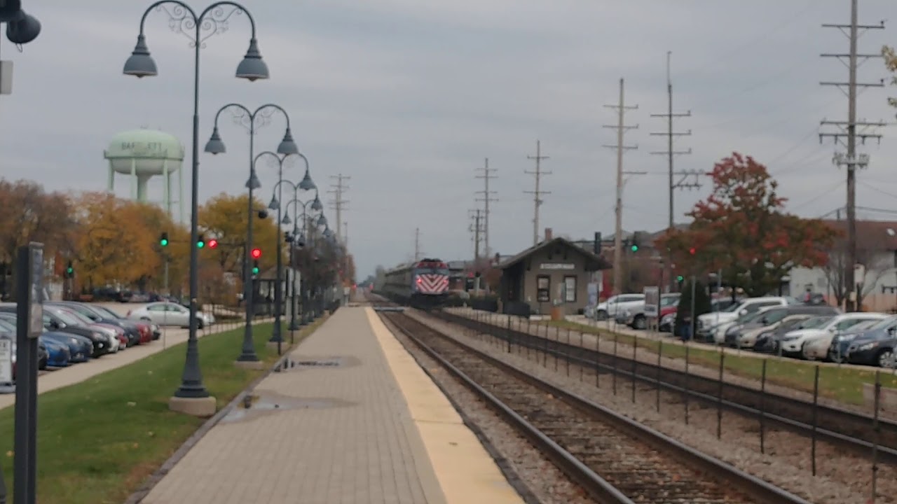 Metra train taking the people to Chicago, in the Bartlett Station, in Bartlett IL.
