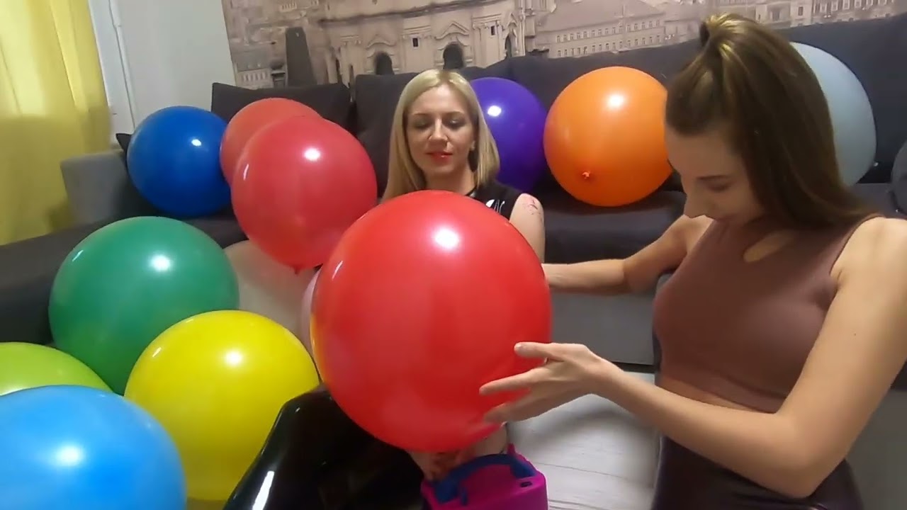 Girls inflate balloons with a pump