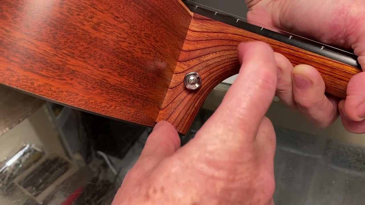 Where should you instal a strap button on an acoustic?