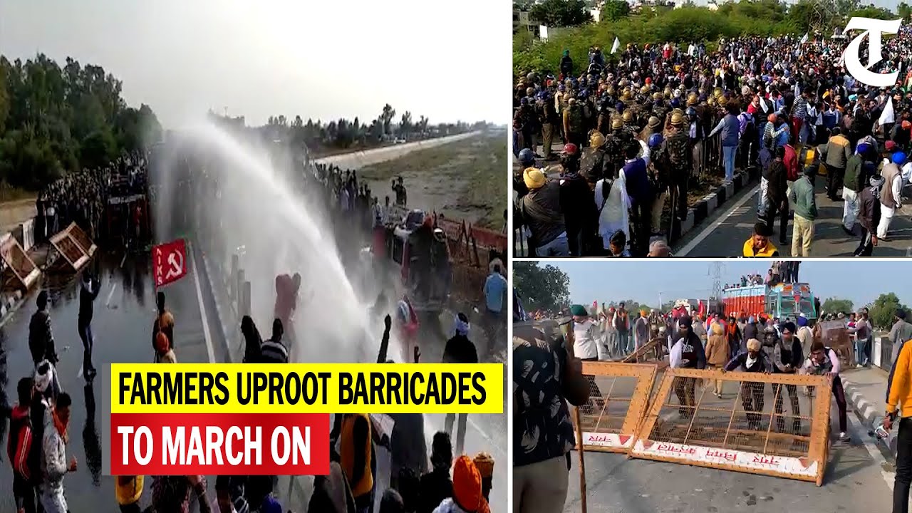 Protesting farmers break barricades as they cross into Haryana for their 'Delhi chalo' march