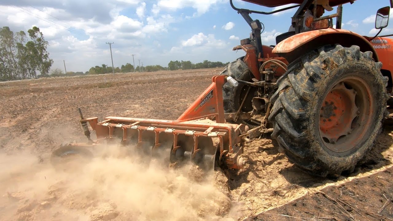 Tractor at work Kubota M6040 fast plowing field