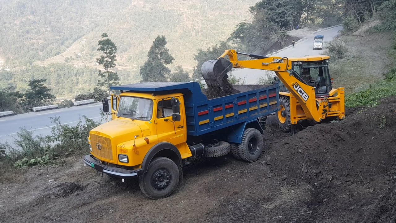 JCB Backhoe Loading Dirt in Dump Truck - JCB Machine Working on Hill Side - Hilly Road Construction