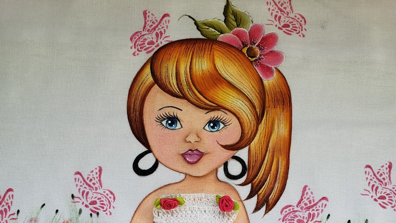 Boneca pintada em pano de prato.