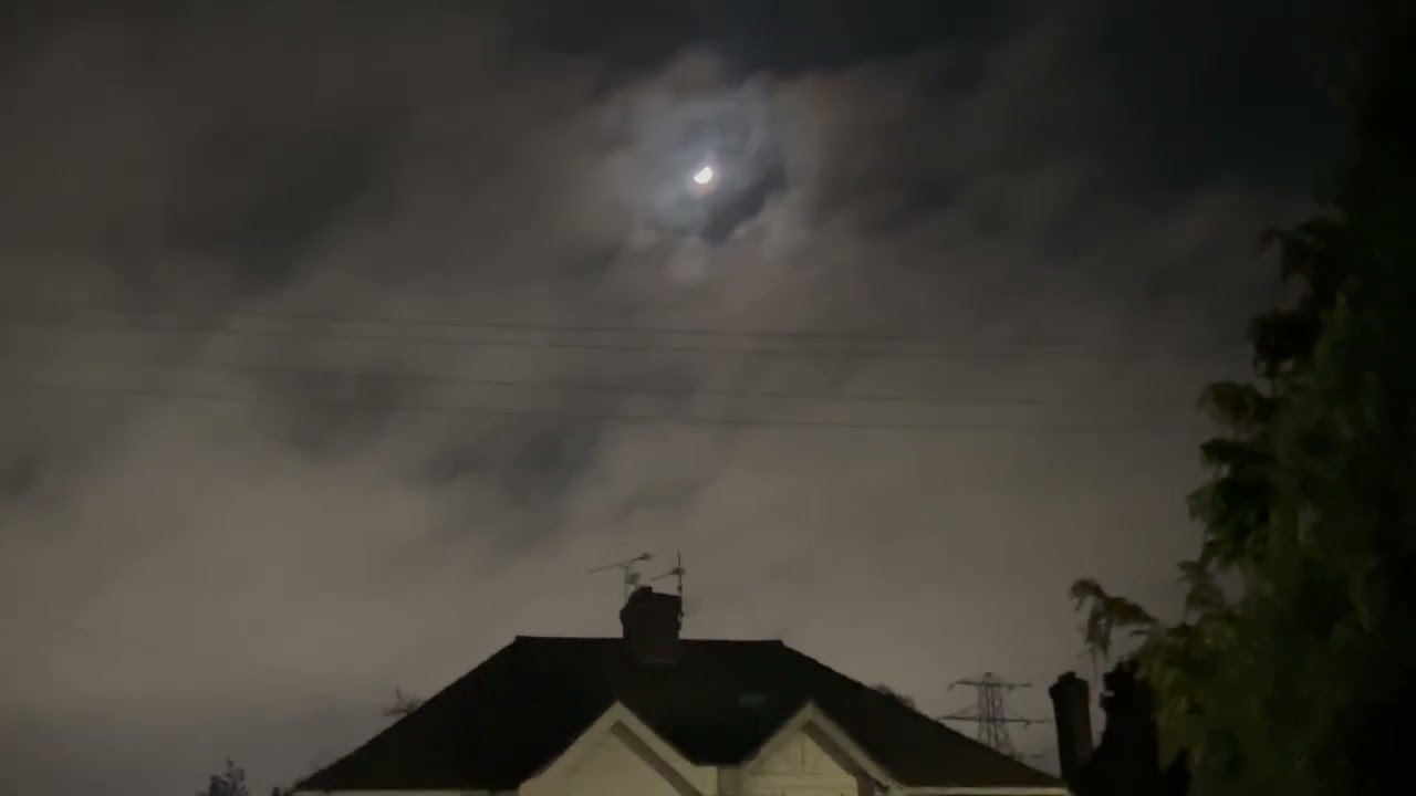 Moon in clouds at midnight moving. 