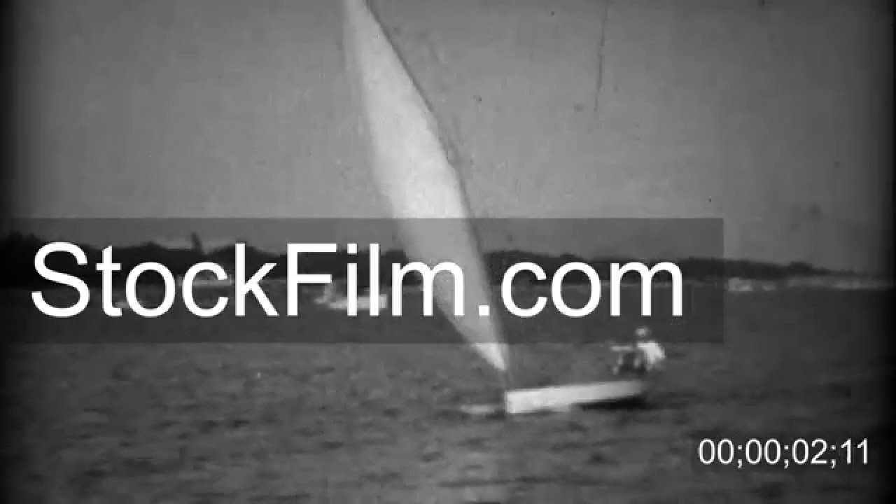 1934: Small sailboat taking 2 passengers across the gentle bay waters. BILOXI, MISSISSIPPI