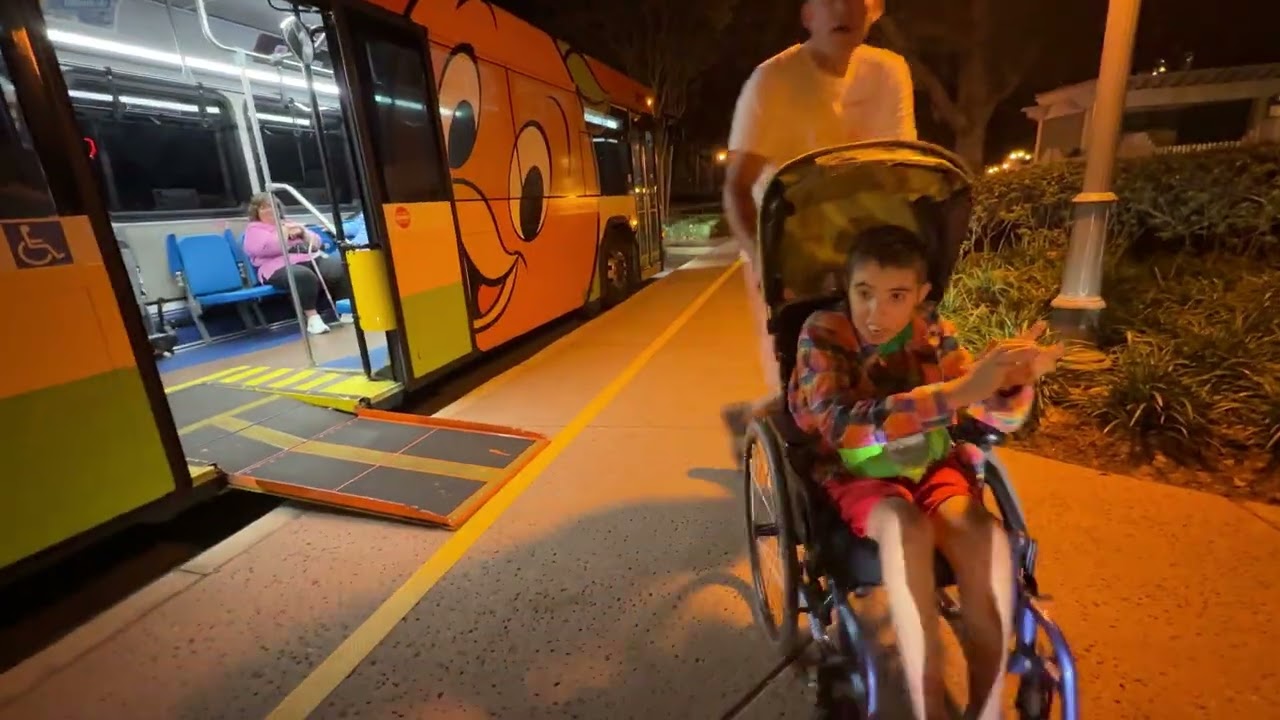 Kayden off Disney Orange Bird Gillig Bus at Saratoga Springs Resort #bus #disney #busstand 