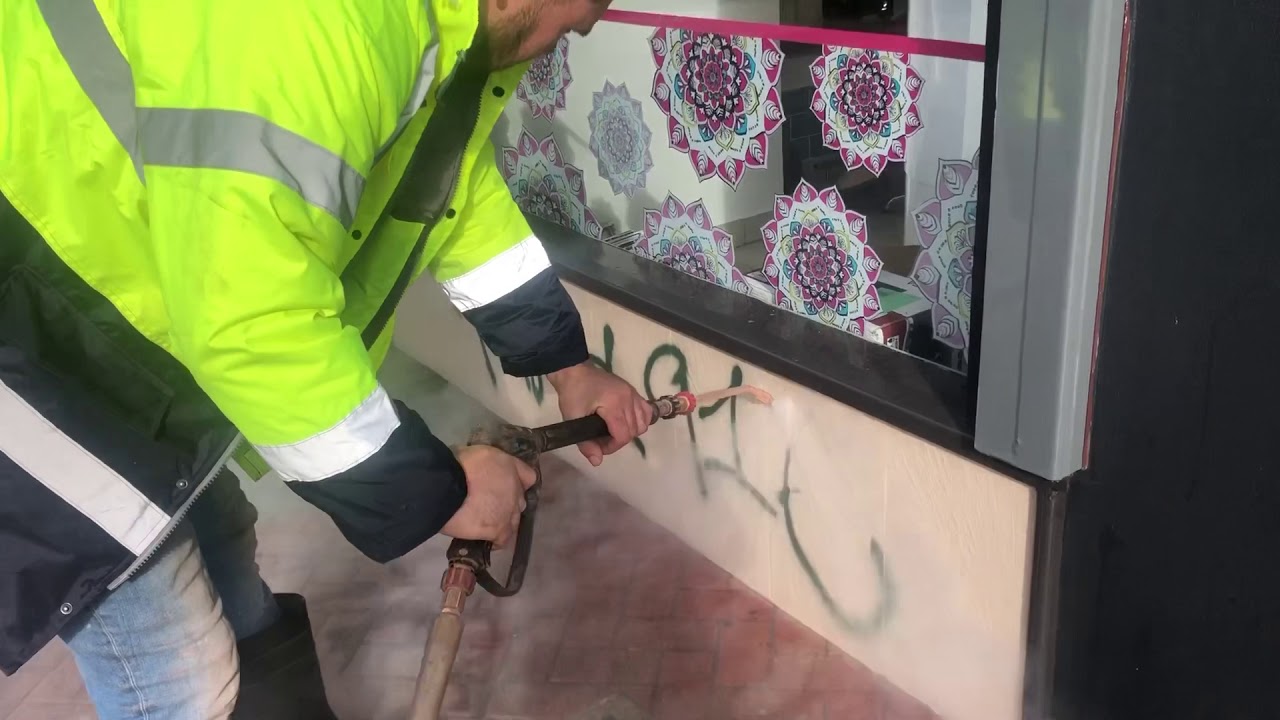 Removing graffiti in London using the Doff steam cleaner & no chemical