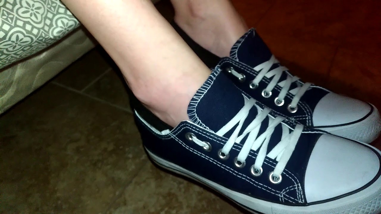 Taking off her blue converse and no show socks