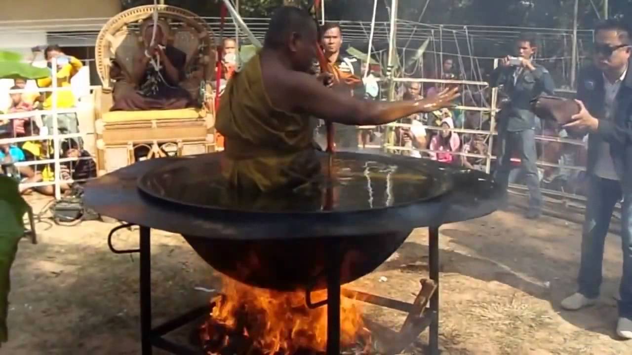 A Buddhist monk meditating in a hot oil container