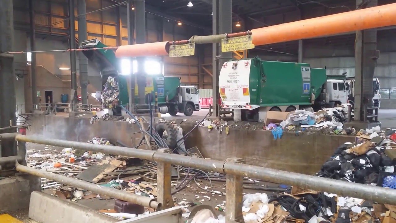 Garbage Trucks and Street Cleaner unload at Tip for Bull Dozer