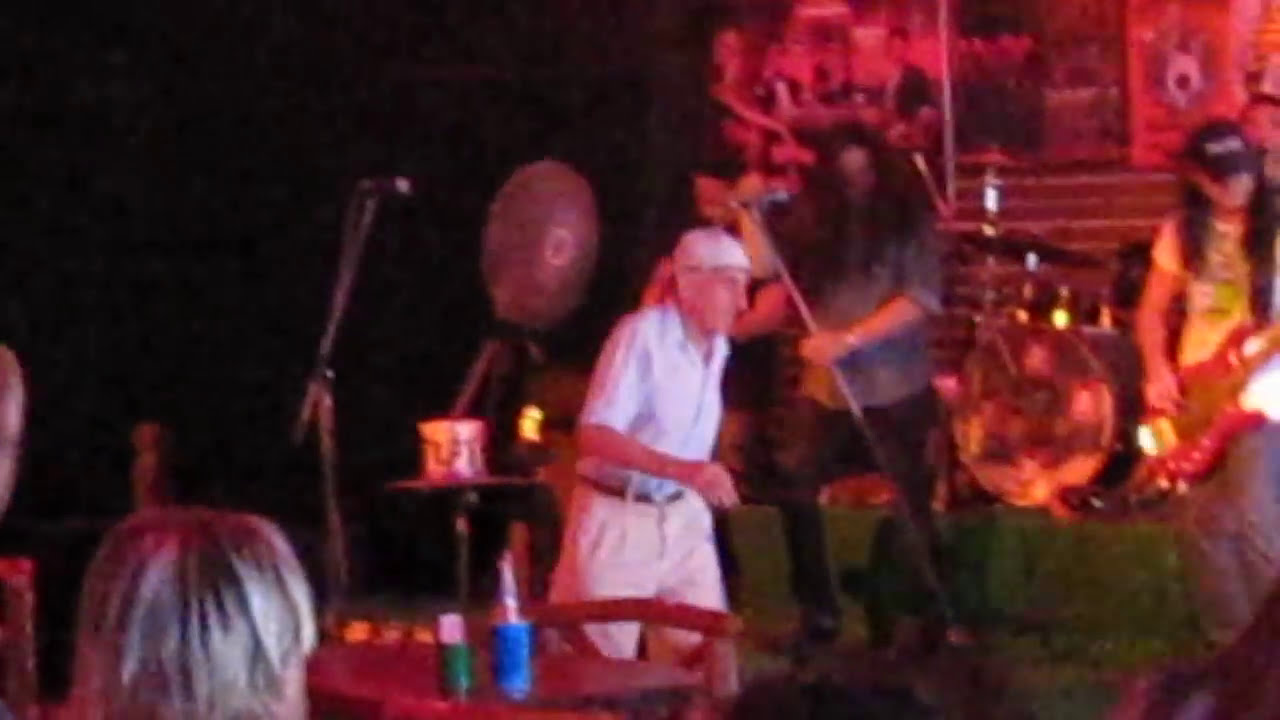 Rock forever!  Funny dancing old man. Walking street. Thailand. Pattaya.