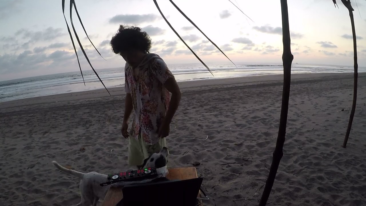 DJ Spinning Tracks Against the Beach Sunset - DJ OREGON -