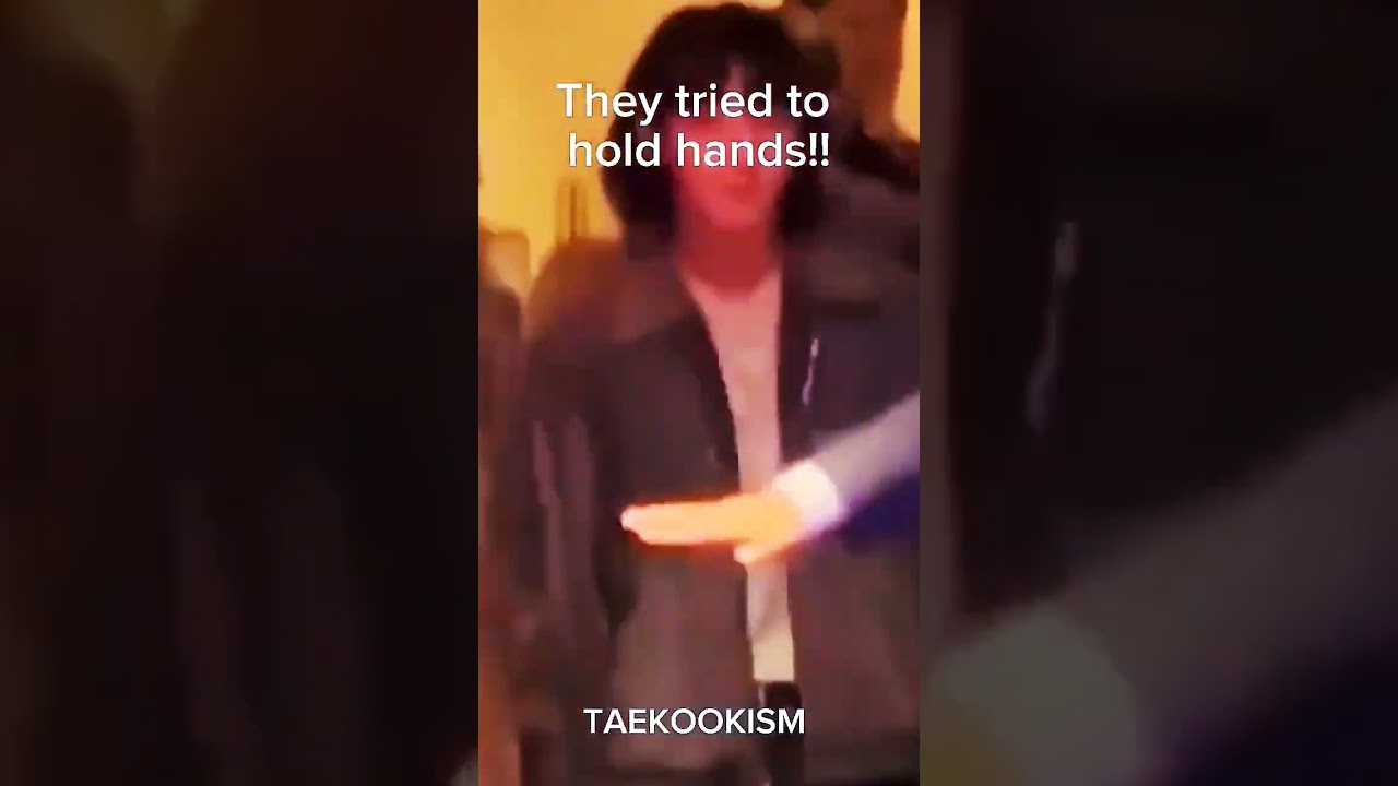 Taekook holding each other's hands in 