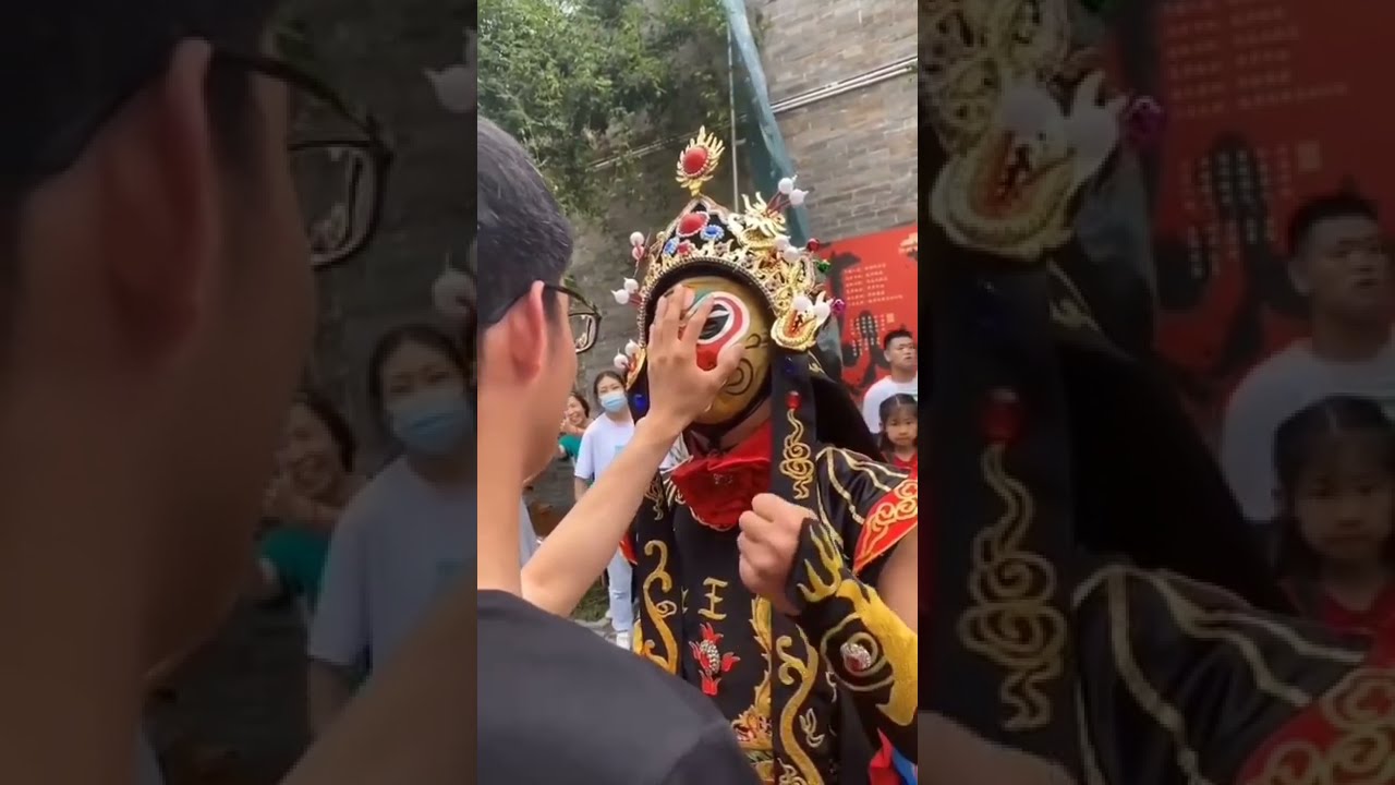 A Bian Lian magic artist changes his mask in no time