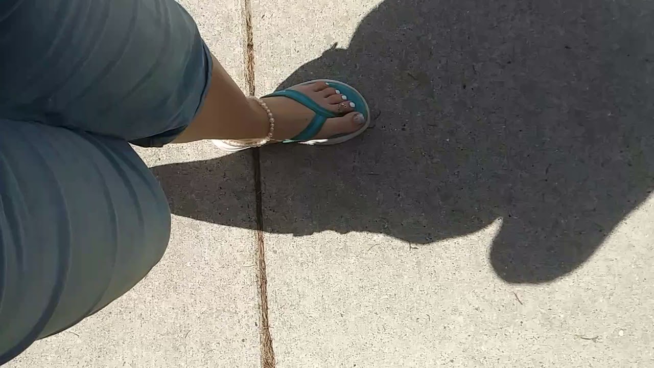 Lola's feet walking in flip flops