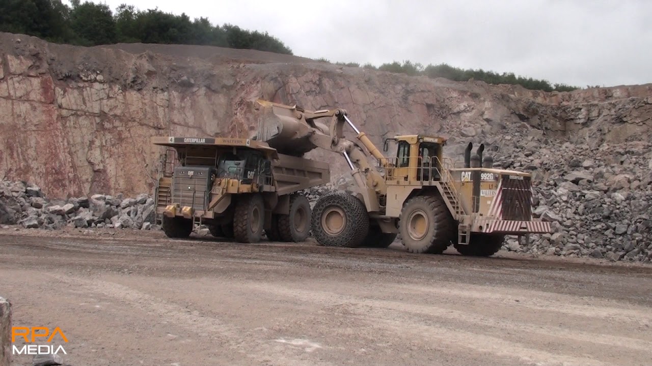 Caterpillar 992G loads Caterpillar 777G trucks in a quarry