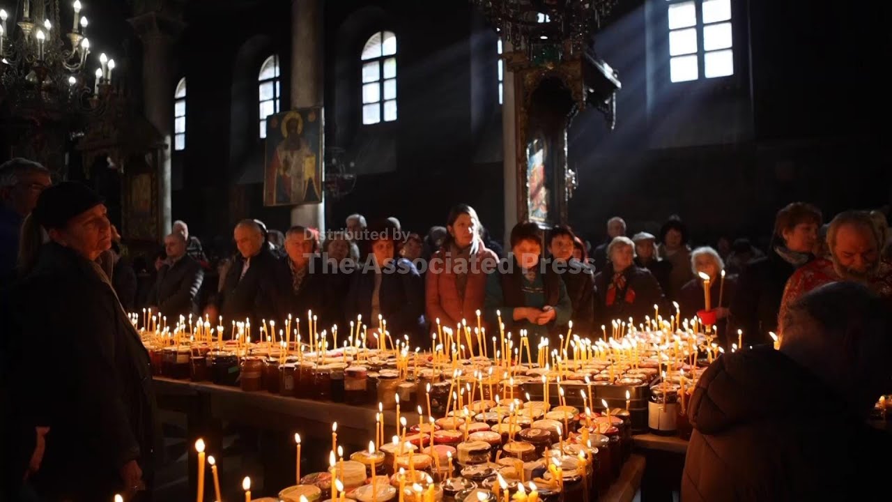 Honey pots form candle lit crucifix as Bulgarian faithful honor Patron Saint of beekeepers