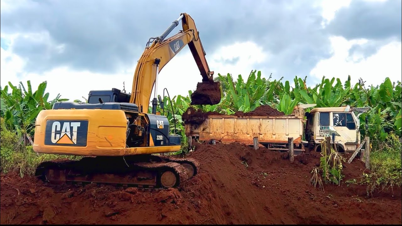 Cat Excavator digs up soil to make a water reservoir