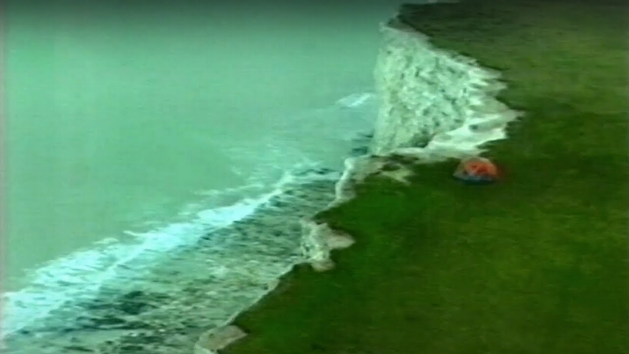 BBC2 ident: Chef Gary Rhodes as mountain climber on white cliffs of Dover & sausage cooking camper.