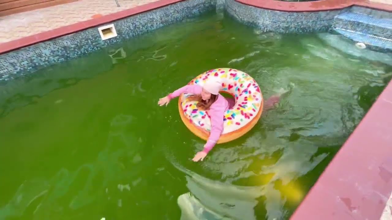 in a pink tracksuit in a green pool