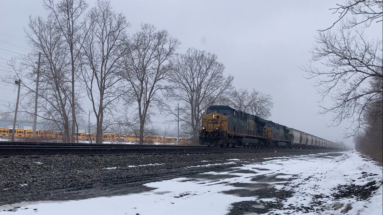 CSX 5428 & 5429 lead a mixed freight train west in the snow 