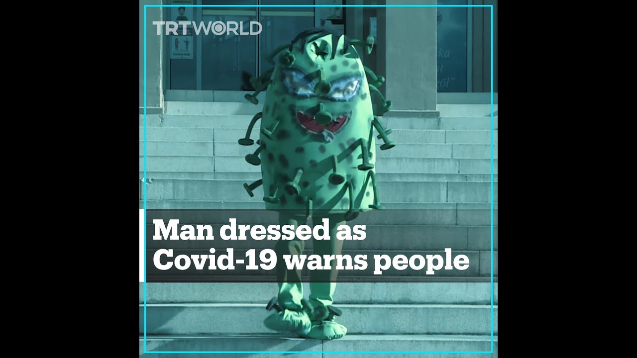 Man in Covid-19 suit warns people to maintain distance