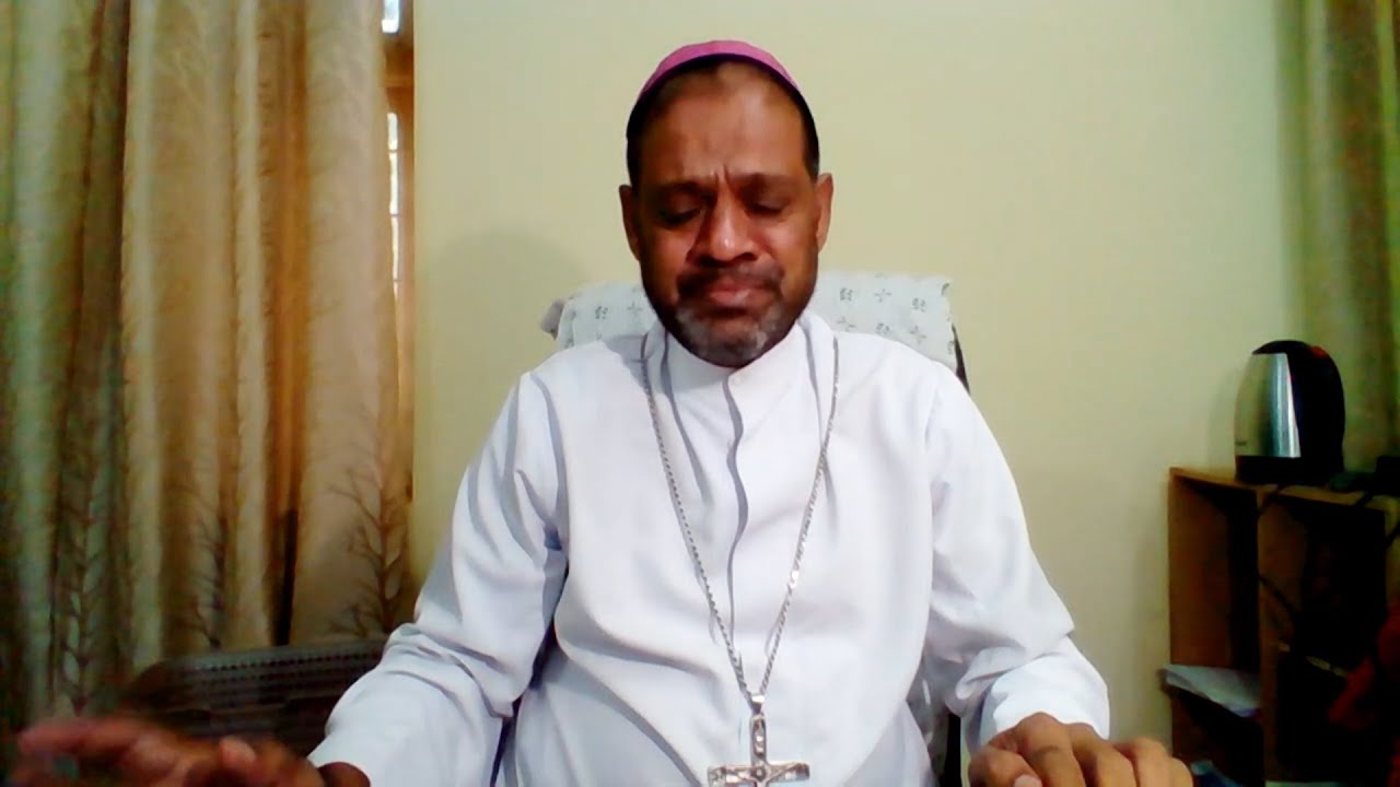 Indian bishop Mascarenhas fights to hold back his tears during TV interview.